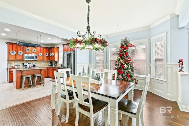 dining area featuring dark hardwood / wood-style floors and ornamental molding