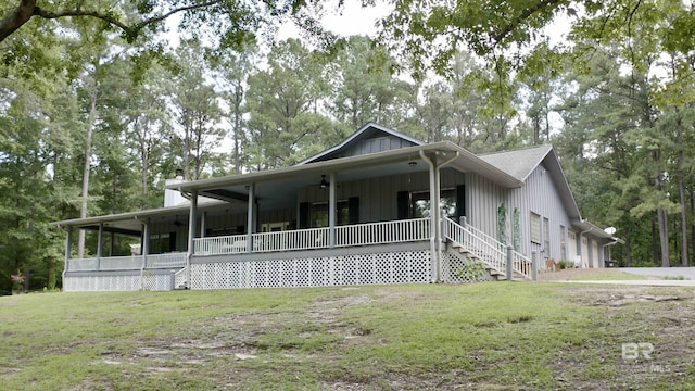 51600 State Highway 59, Bay Minette, AL 36507 - view of front facade featuring covered porch, a front yard, a chimney, a ceiling fan, and view of scattered trees