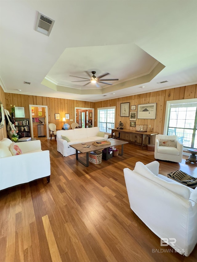 51600 State Highway 59, Bay Minette, AL 36507 - living area with a raised ceiling, wooden walls, plenty of natural light, ceiling fan, and ornamental molding