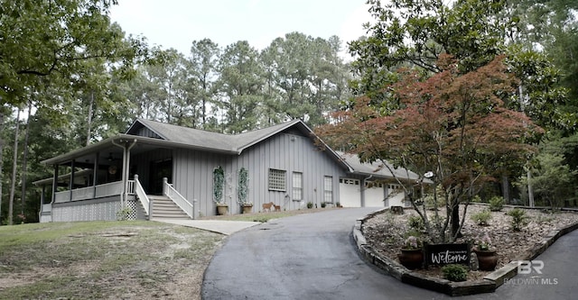 51600 State Highway 59, Bay Minette, AL 36507 - view of front of home featuring board and batten siding, driveway, covered porch, and an attached garage