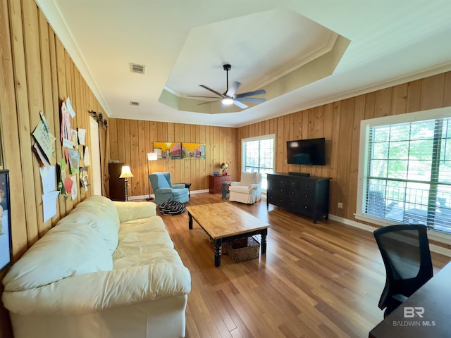 51600 State Highway 59, Bay Minette, AL 36507 - living room with a raised ceiling, wood walls, wood finished floors, a ceiling fan, and ornamental molding