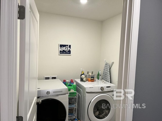 washroom featuring separate washer and dryer and laundry area