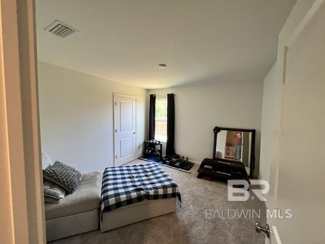 carpeted bedroom featuring visible vents