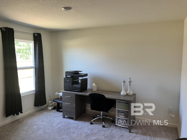home office with carpet, a textured ceiling, and baseboards