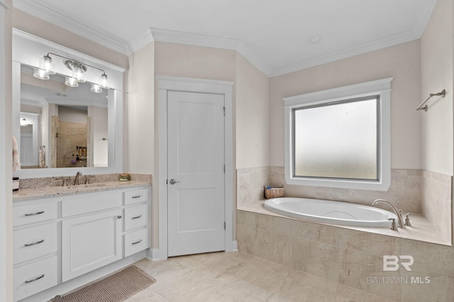 bathroom with ornamental molding, vanity, and tiled tub