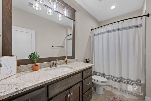 bathroom featuring vanity, tile patterned flooring, toilet, and walk in shower