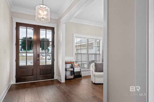 doorway to outside with crown molding, a notable chandelier, dark hardwood / wood-style floors, and french doors