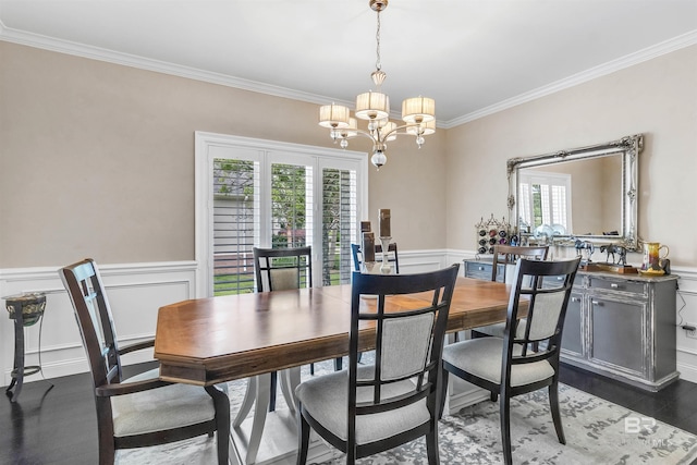 607 Wedgewood Dr, Gulf Shores, AL 36542 - dining space featuring crown molding, a chandelier, a wainscoted wall, wood finished floors, and a decorative wall