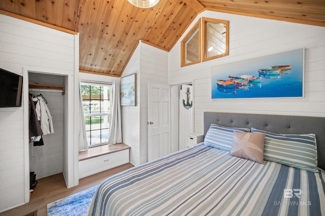 bedroom with hardwood / wood-style floors, wood ceiling, wooden walls, and vaulted ceiling