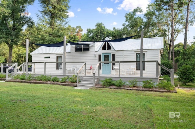 view of front of home featuring a front lawn and a deck