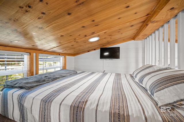 bedroom featuring vaulted ceiling, wooden ceiling, and wood walls