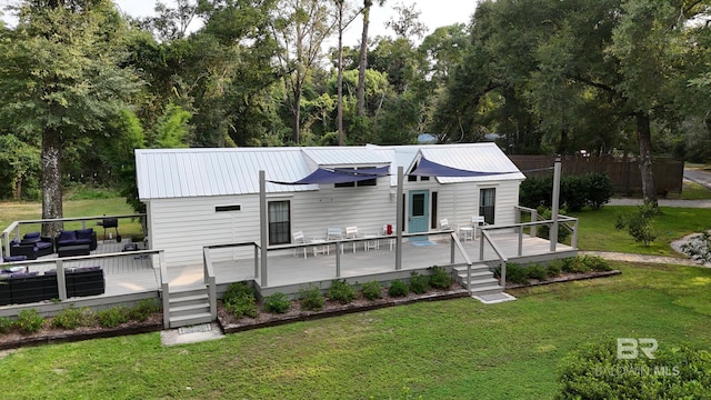 view of front of property featuring a front yard and a deck