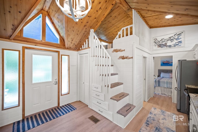 foyer entrance featuring wood ceiling, high vaulted ceiling, light hardwood / wood-style flooring, and beamed ceiling