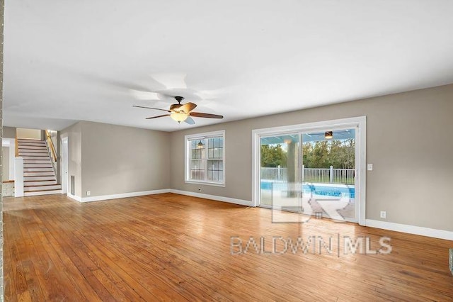 unfurnished living room featuring ceiling fan and light hardwood / wood-style flooring