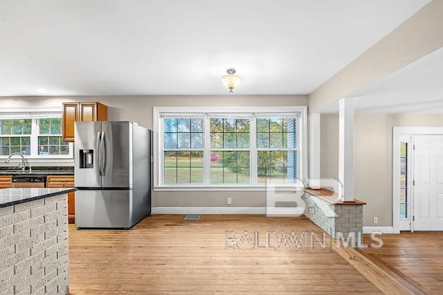 kitchen with plenty of natural light, light wood-type flooring, and stainless steel appliances