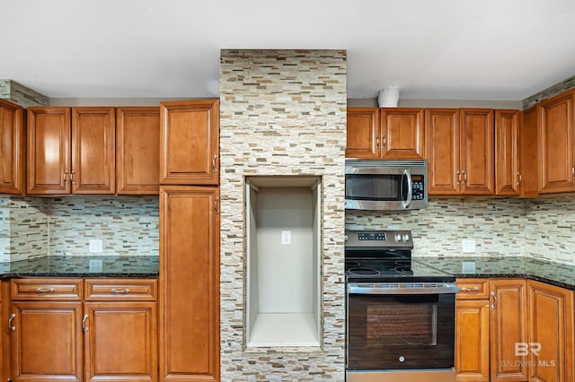 kitchen featuring backsplash, stainless steel appliances, and dark stone counters