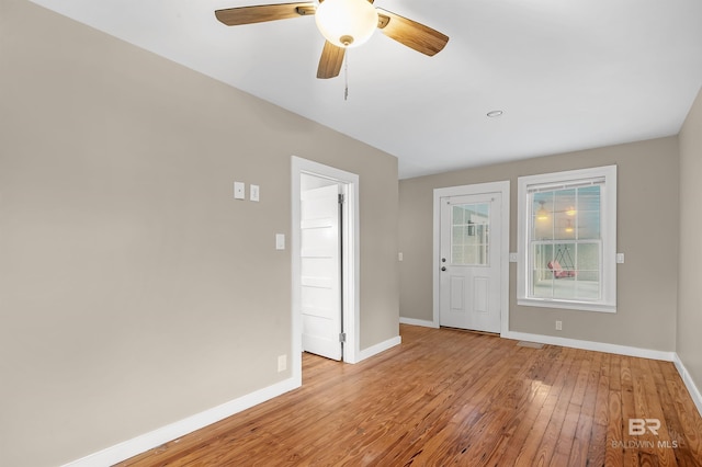 unfurnished room with ceiling fan and light wood-type flooring