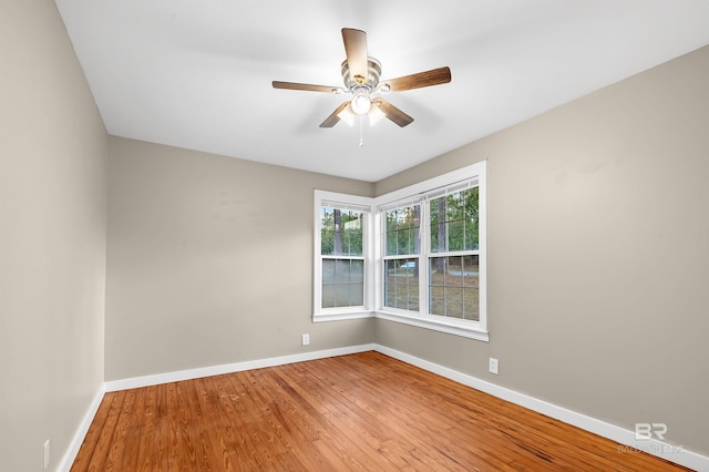 empty room with ceiling fan and hardwood / wood-style floors