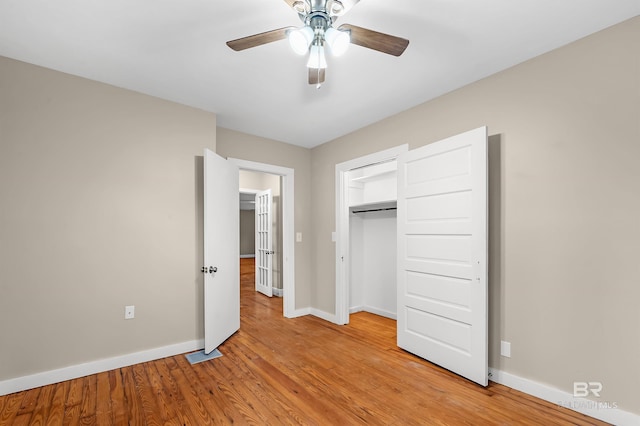 unfurnished bedroom featuring ceiling fan, light wood-type flooring, and a closet