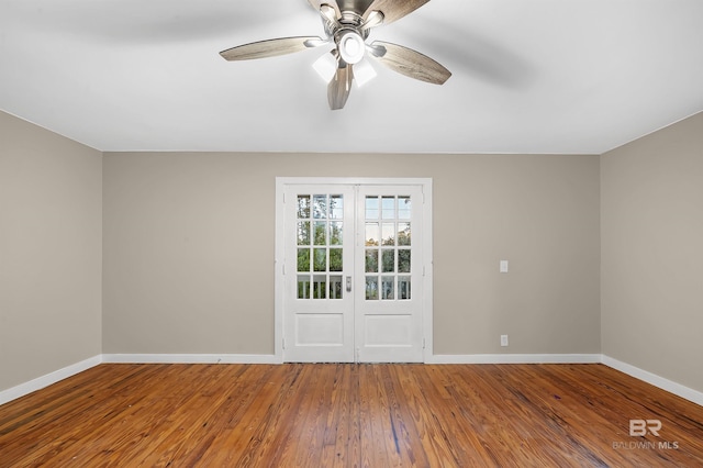 unfurnished room with hardwood / wood-style flooring, ceiling fan, and french doors