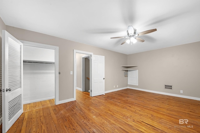 unfurnished bedroom featuring ceiling fan, a closet, and light hardwood / wood-style floors