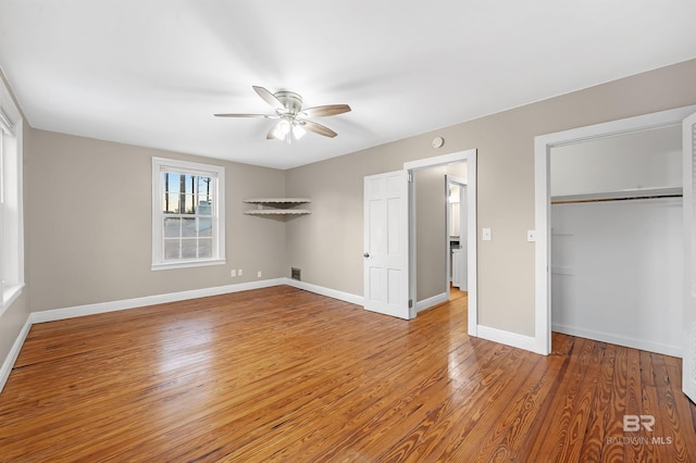 unfurnished bedroom with wood-type flooring, a closet, and ceiling fan