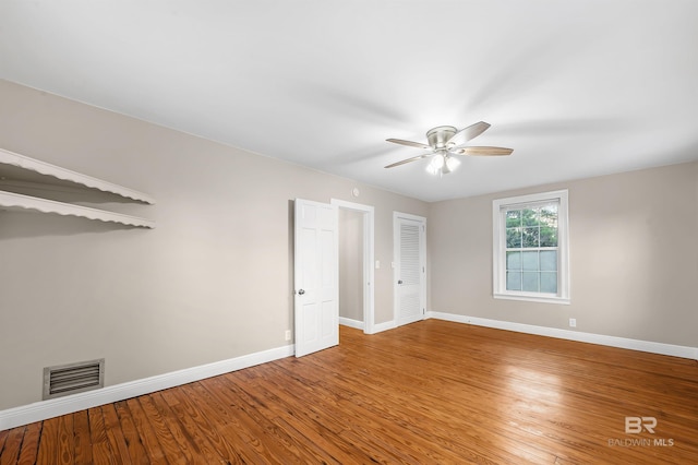 spare room featuring ceiling fan and hardwood / wood-style flooring