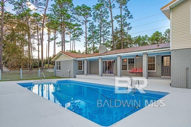 view of swimming pool featuring a patio area