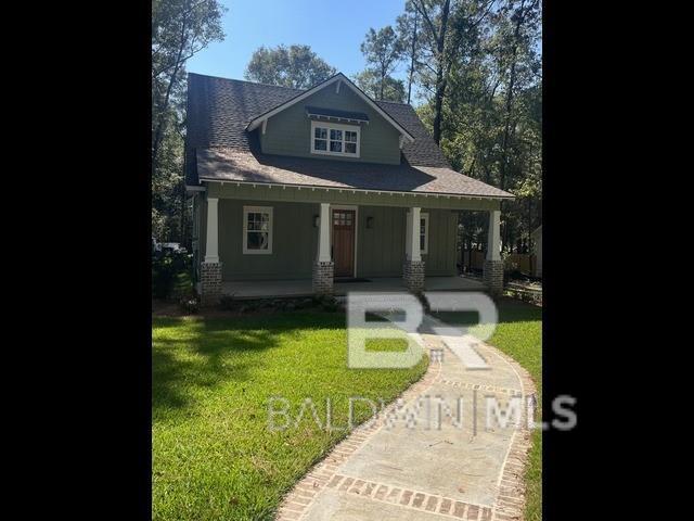 craftsman house with a porch and a front yard