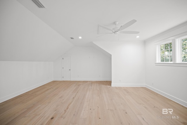 additional living space with ceiling fan, light hardwood / wood-style floors, and vaulted ceiling