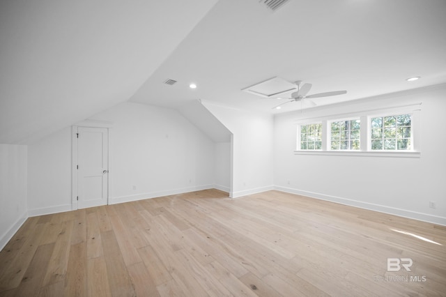 additional living space with ceiling fan, lofted ceiling, and light wood-type flooring