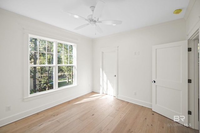 spare room with ceiling fan, light hardwood / wood-style floors, and ornamental molding