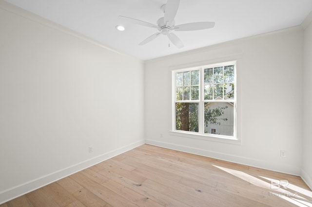 spare room featuring light hardwood / wood-style floors, ceiling fan, and crown molding