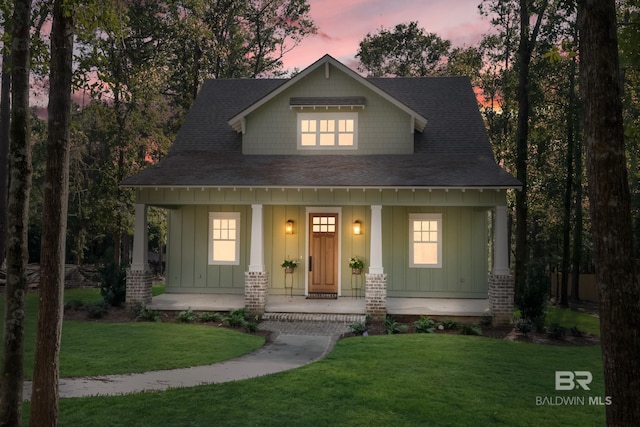 view of front facade featuring a porch and a lawn