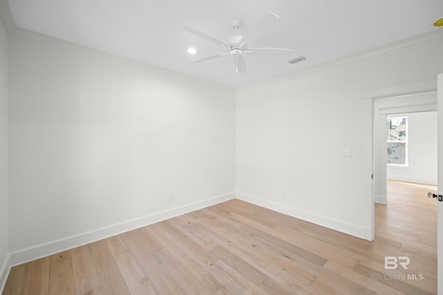 empty room featuring crown molding, light hardwood / wood-style flooring, and ceiling fan