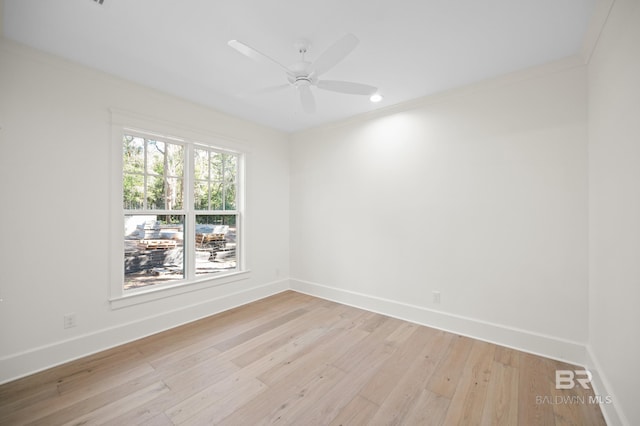 empty room with ceiling fan, light hardwood / wood-style floors, and ornamental molding