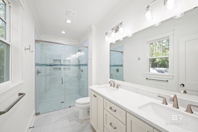 bathroom with vanity, toilet, ornamental molding, and a shower with door