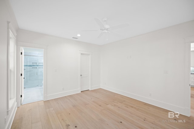 spare room featuring light hardwood / wood-style floors, ceiling fan, and crown molding