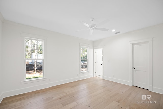 unfurnished room with light hardwood / wood-style floors, ceiling fan, and ornamental molding