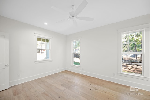 unfurnished room with ceiling fan, a healthy amount of sunlight, and light hardwood / wood-style flooring