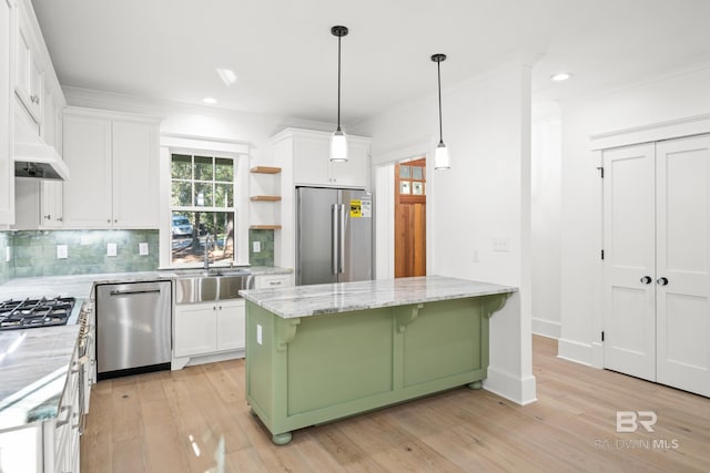 kitchen with appliances with stainless steel finishes, light hardwood / wood-style flooring, white cabinetry, and sink