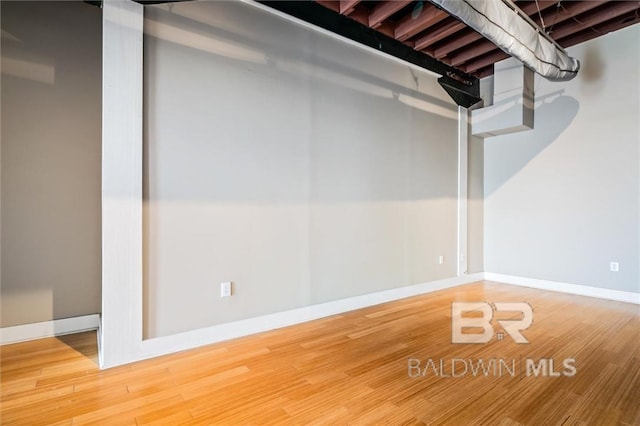 basement with hardwood / wood-style flooring