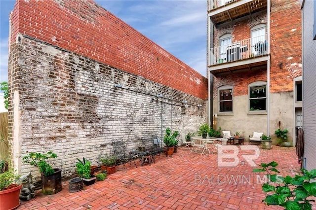 view of patio featuring a balcony