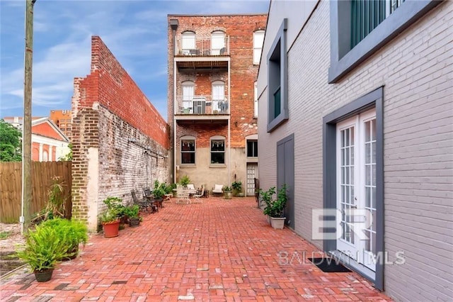 view of patio / terrace featuring a balcony and french doors