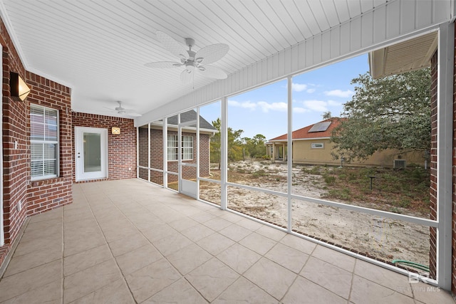 unfurnished sunroom featuring ceiling fan