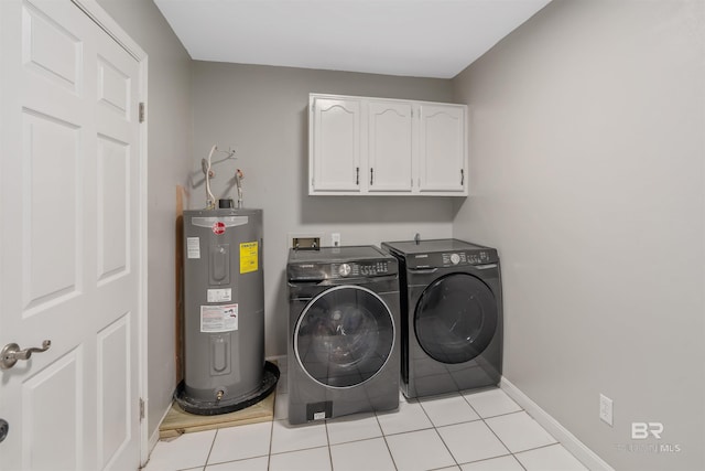 laundry area featuring light tile patterned flooring, cabinets, washing machine and clothes dryer, and water heater