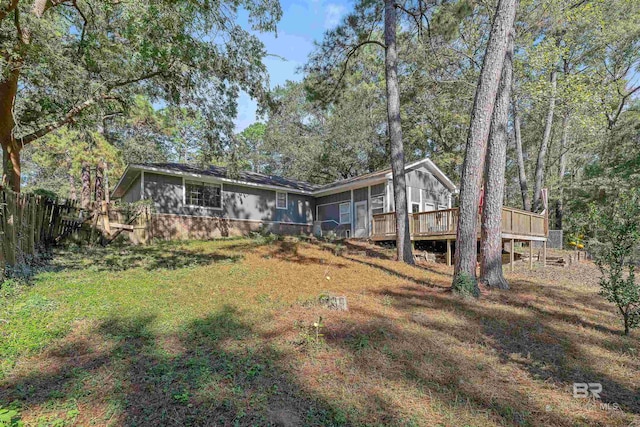 view of front of home featuring a deck and a front lawn