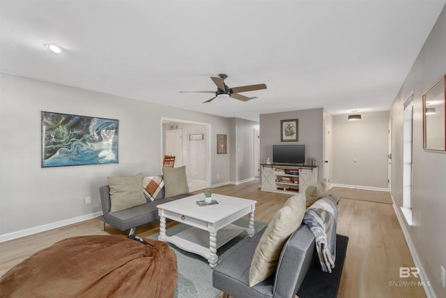 living room with ceiling fan and light hardwood / wood-style floors