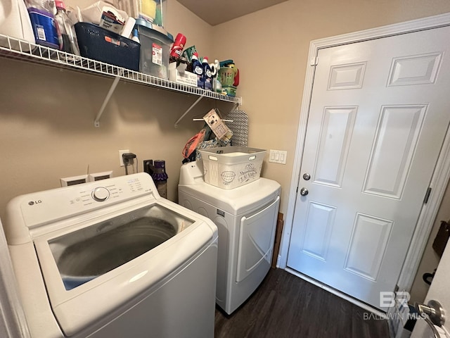 laundry room featuring washer and clothes dryer and dark hardwood / wood-style floors