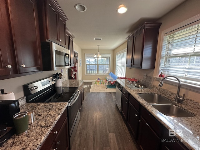 kitchen with sink, decorative light fixtures, dark hardwood / wood-style flooring, stainless steel appliances, and a chandelier